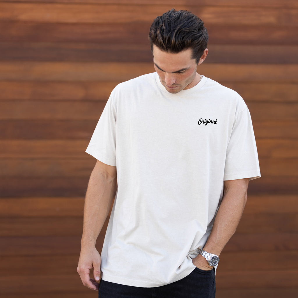 Model wearing Original Vintage Tee front view in pigment ivory with chest wordmark.
