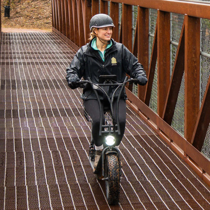 Rider on the Hiboy U2 Pro crossing a bridge with the headlight on
