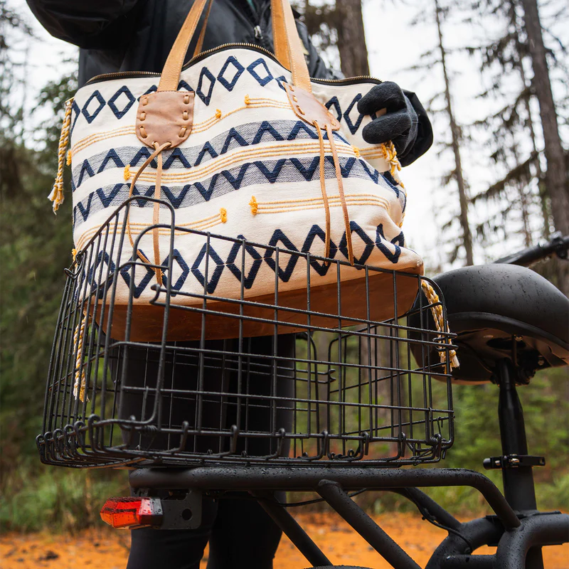Close up of the Hiboy U2 Pro rear basket carrying a tote bag on a forest trail
